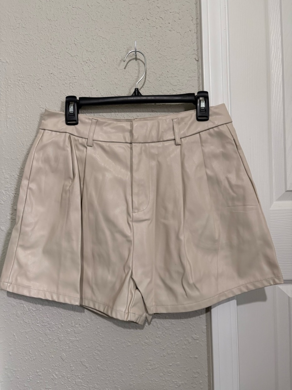 Shinestar High-Waist Pleated Faux Leather Shorts in Cream Beige